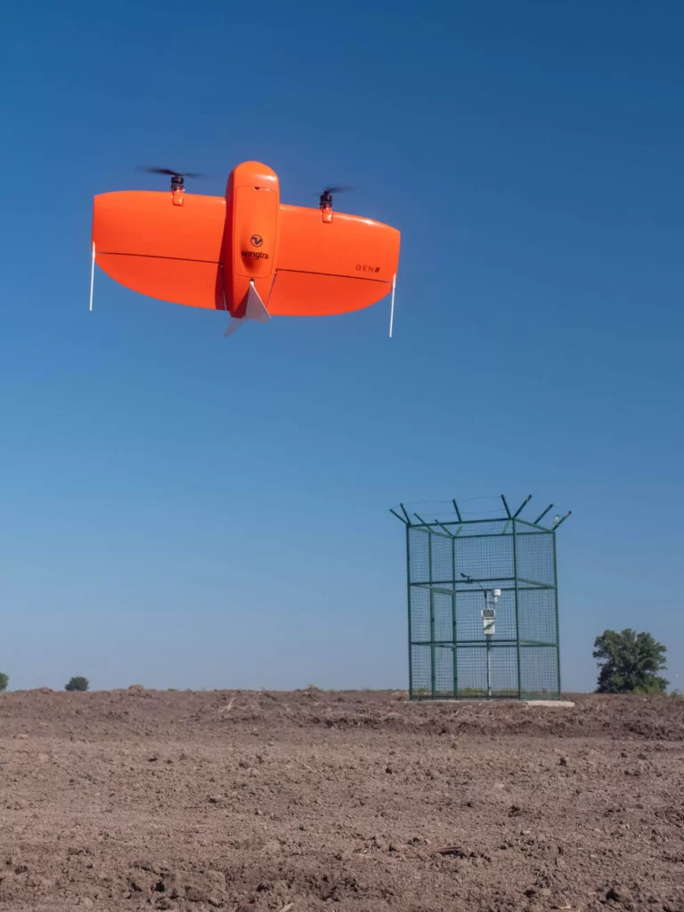 Wingtra drone taking off on the field, flying above sustainable farm.