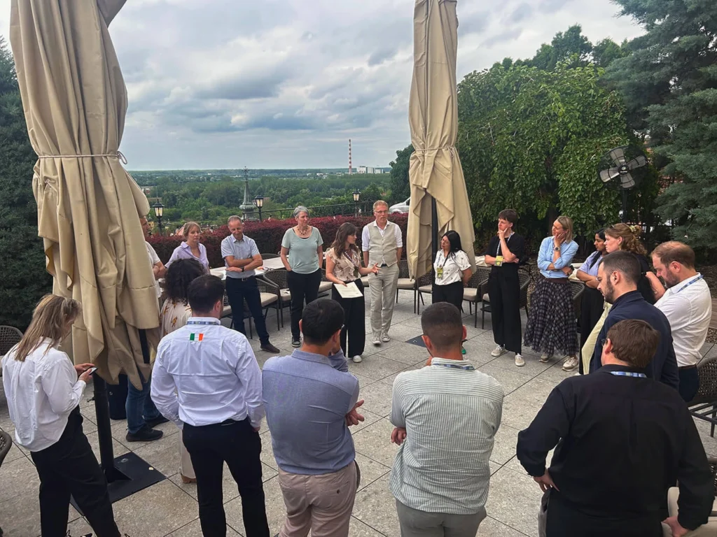 Participants standing in a circle for an embodied mapping exercise on a terrace overlooking the river at Petrovaradin Fortress